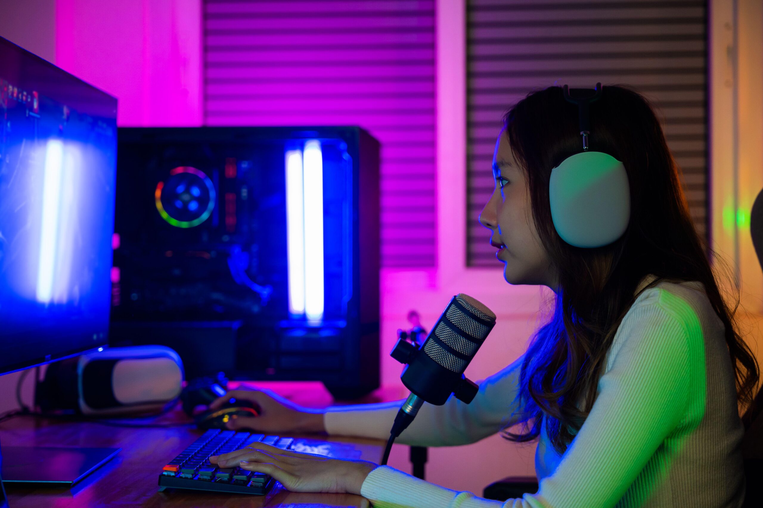 a woman playing Blue Prince on her PC while talking to her friends on a mic